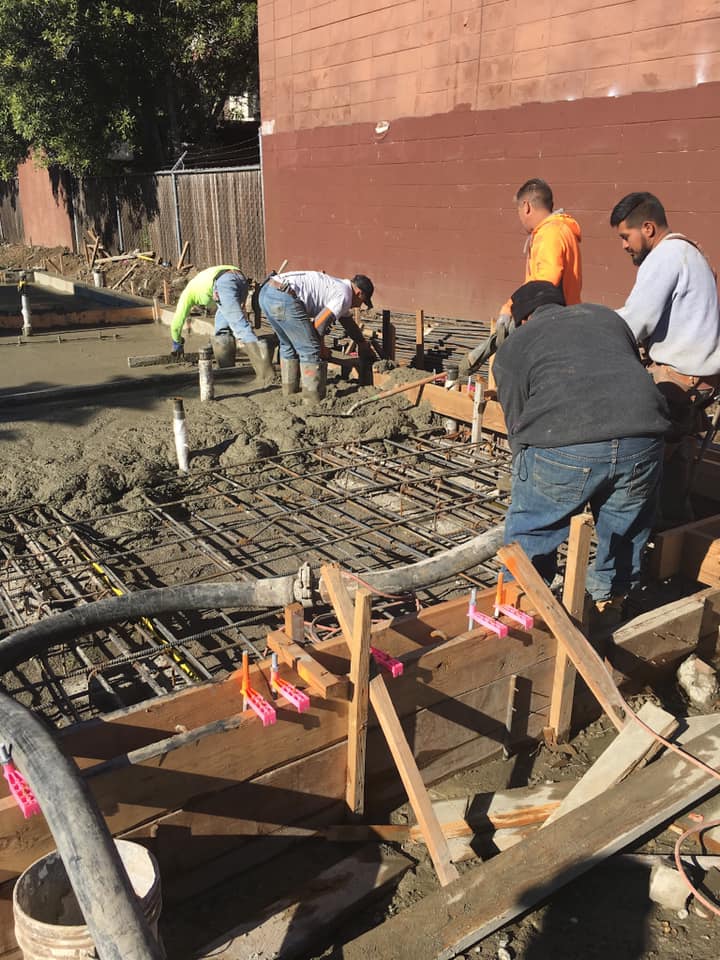 A group of employees working with plumbing pipes and materials